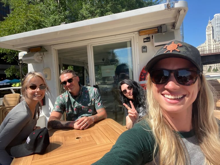 From left to right: Lauren San Gregory, Curtiss Gulash, Kyrin Field, and Maggie Sauer pose for a selfie on the Island Party Boat on the Chicago River